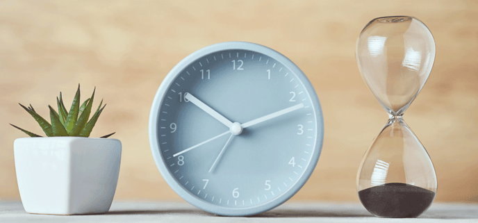 hourglass-alarm-clock-and-plant-on-the-table-clo-2022-10-27-23-09-45-utc